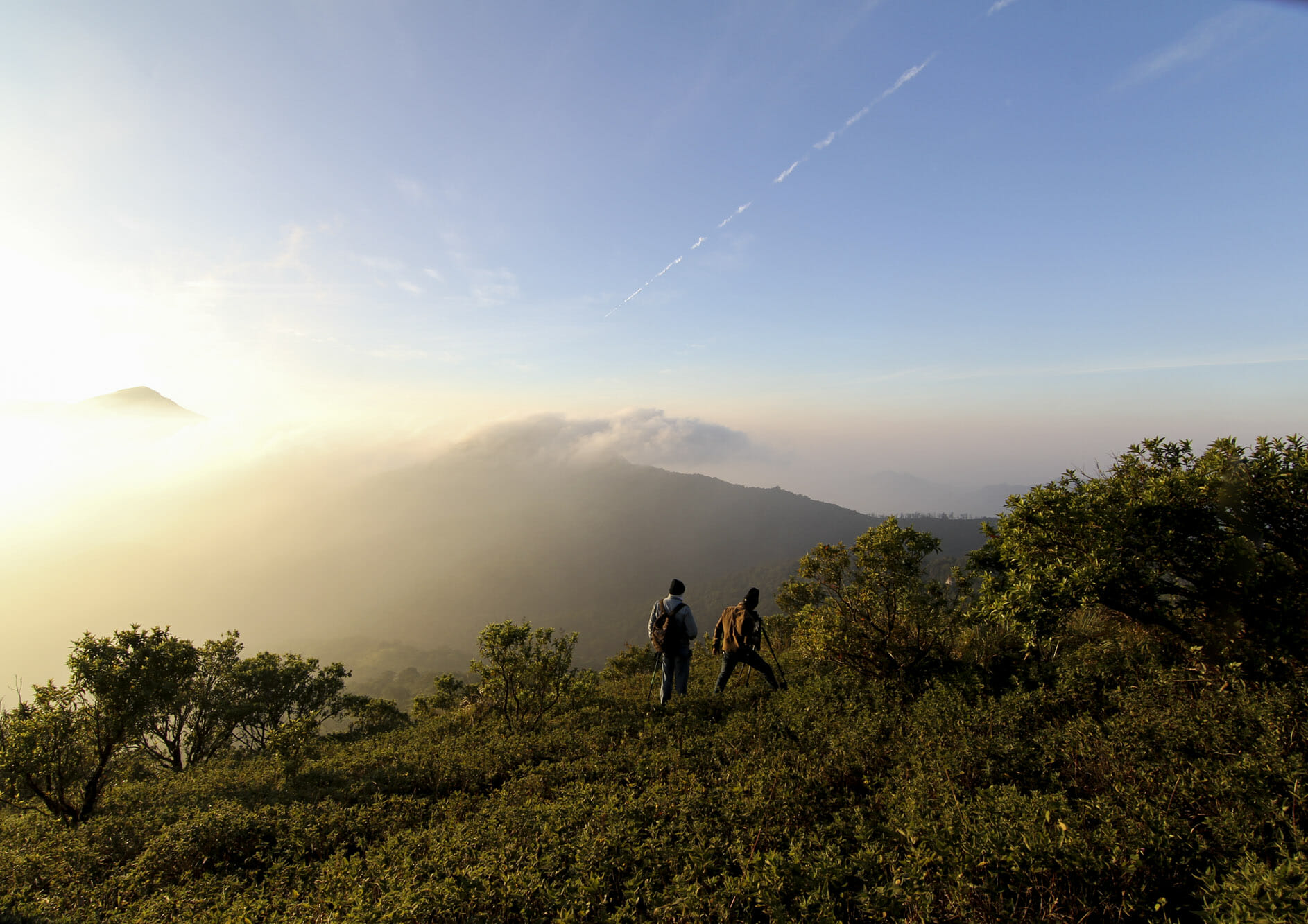 Man-hiking-at-sunrise-mountains-with-backpack